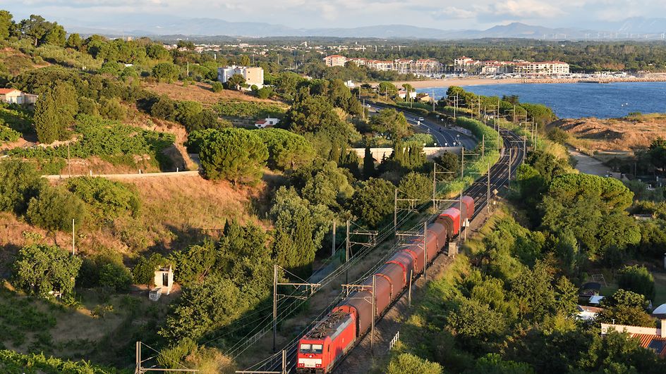 Freight train runs along the coast