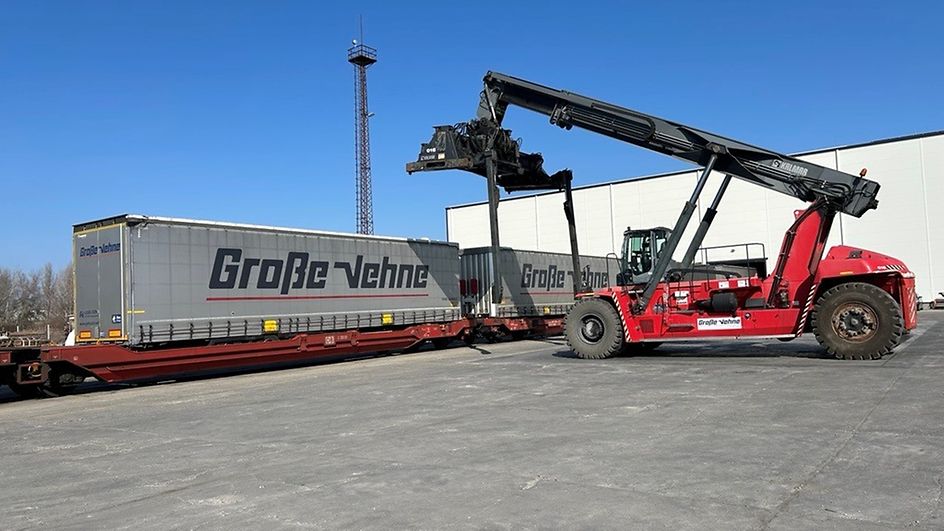 Reach stacker loads trailers in the transshipment terminal