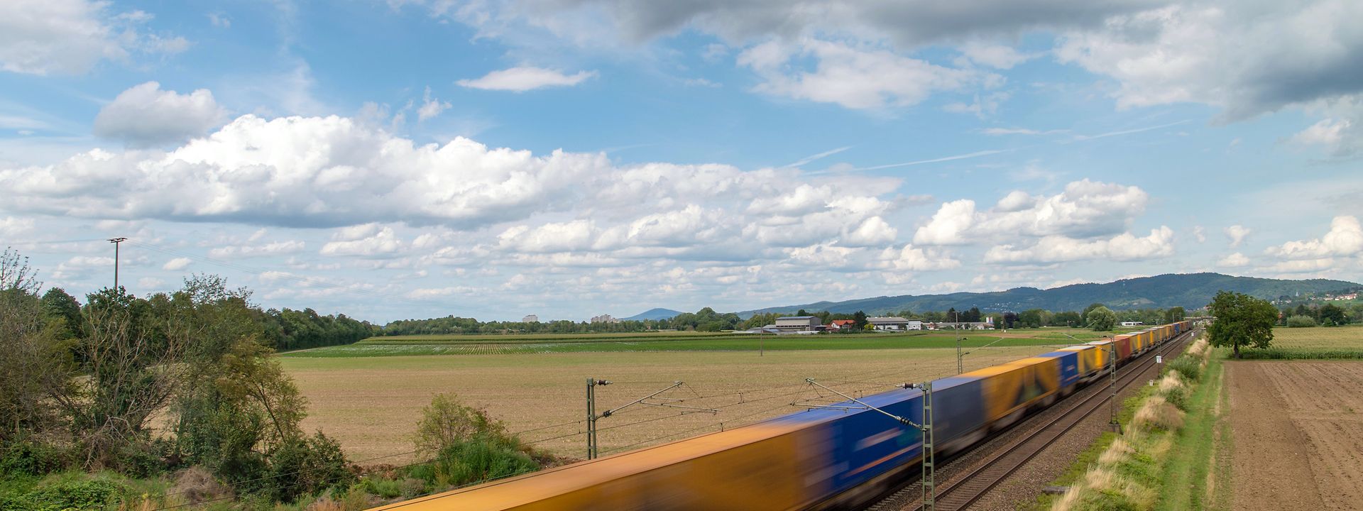 Train with swap bodies speeds through the countryside