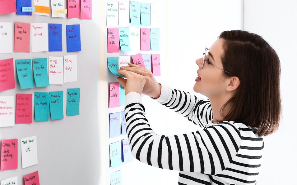 Woman standing by a pinboard