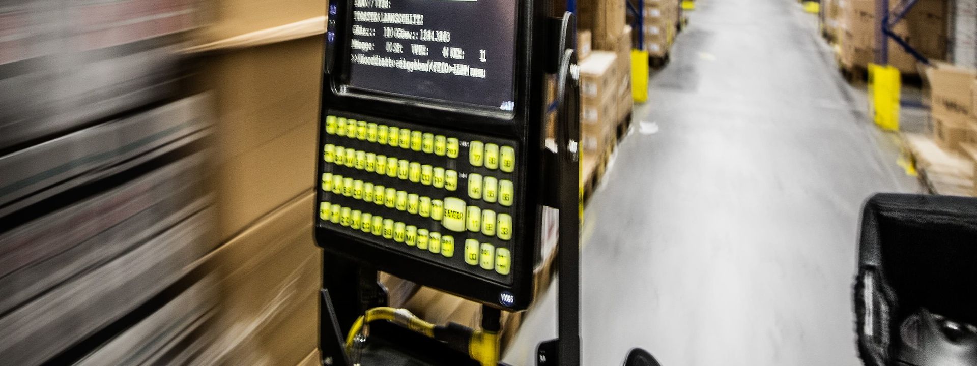 Forklift truck drives between shelf lines in a warehouse